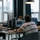 Team of developers working together on computers in a modern tech office.